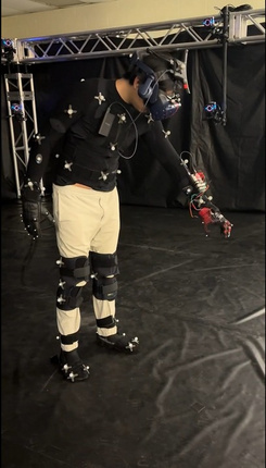 Person in a full motion-capture suit and VR headset during a glove test session