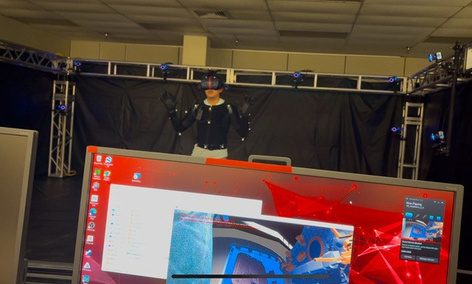 Motion-capture volume with a monitor showing live hand tracking